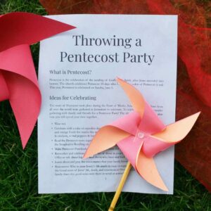 Photo of the interior of the Pentecost Party Packet. The page is titled "Throwing a Pentecost Party," and has a pinwheel and a red cloth next to it.