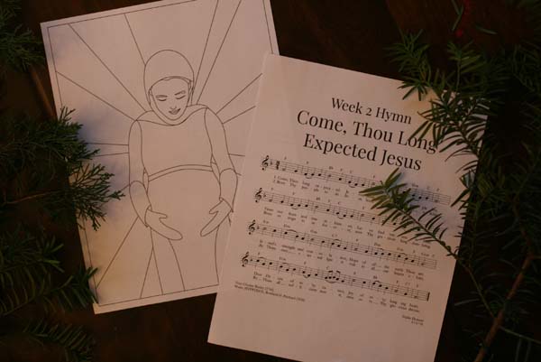 Photo of advent cards. First page shows an illustration of pregnant Mary looking down at her belly. The second page shows Week 2 Hymn, Come Thou Long Expected Jesus.