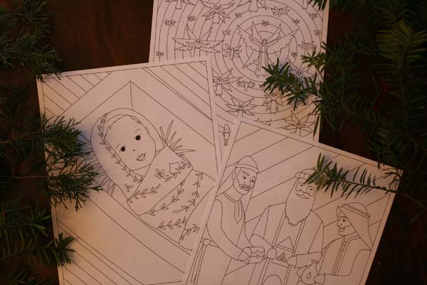 Photo of advent card illustrations. Illustrations include baby Jesus in the manger, the sky full of angels, and the three wise men.