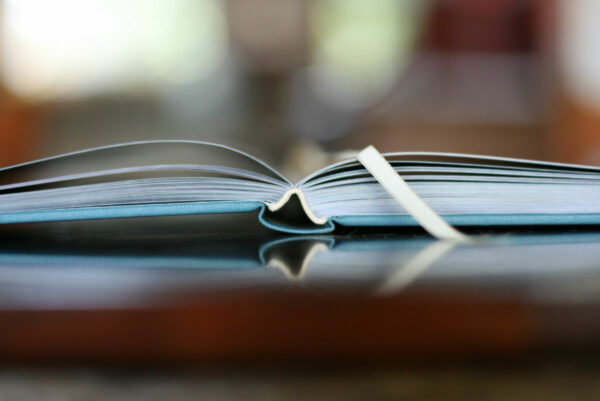 photo of the Gospel Story Hymnal's binding as it lays flat on a table.
